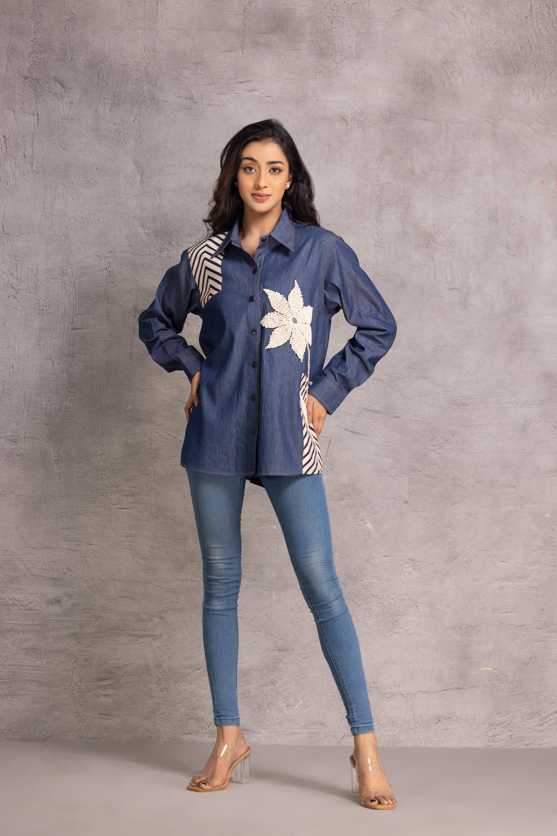 Denim shirt with 3D motif created using innovative tape-work detailing.