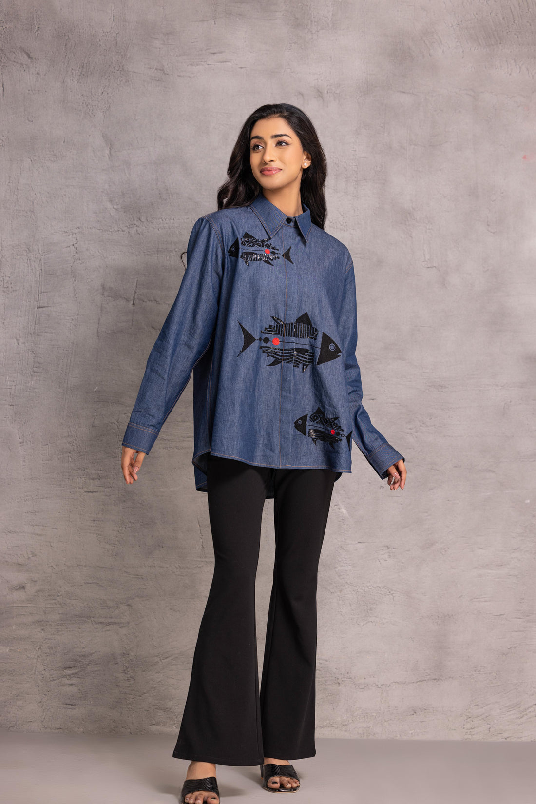 Denim  shirt with a fish motif enhanced by sequin and thread work.