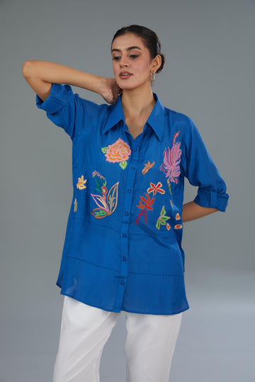 Blue COTTON SILK  loose-fit shirt with a sheer finish and patchwork floral motifs, creating an elegant and joyful look