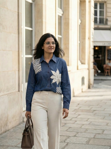 Denim shirt with 3D motif created using innovative tape-work detailing.