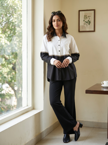 Black-and-white cotton  shirt enhanced with tape work and anchore chawal taka detailing.